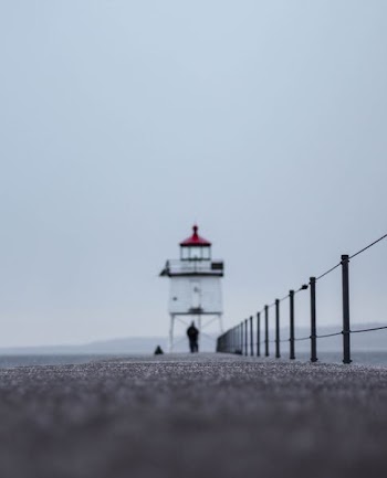 white lighthouse under gray sky during daytime