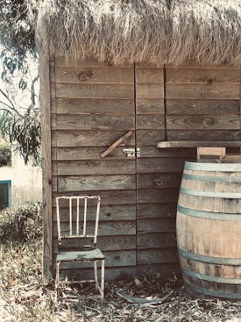 White Metal Chair Beside Brown Wooden Barrel