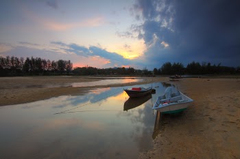 White Motorboat Near Brown Motorboat on Calm Body of Water