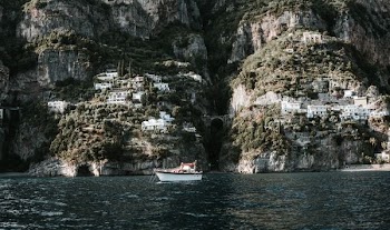 white motorboat on body of water