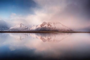 white mountain by the sea during daytime