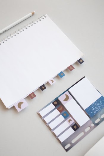 White Notebook and Stationery on a White Surface