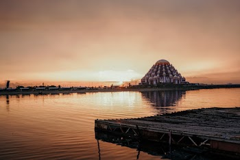 White Painted Building Between Body of Water