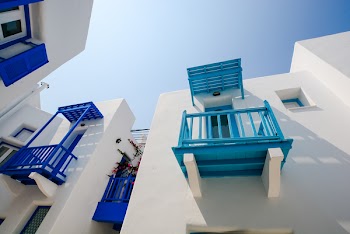 White Painted House With Blue and Teal Terrace