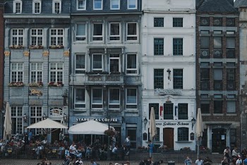 white patio umbrellas in front of buildings