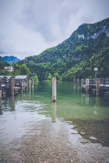 white post on body of water