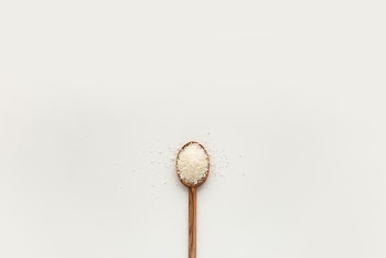 white powder on brown wooden spoon