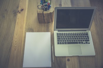White Printer Paper Beside Macbook Air