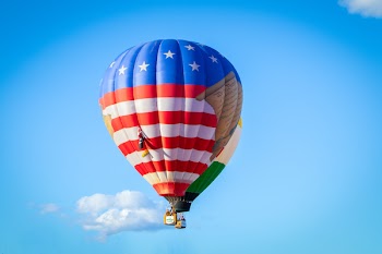 White, Red, and Blue Hot Air Balloon Flying