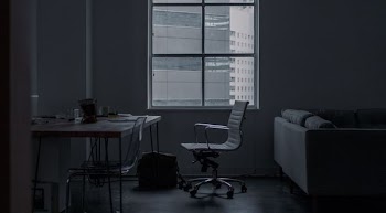 white rolling armchair in front of table