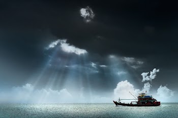 White Sail Bot Under Gray Clouds