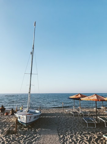 White Sailboat Docked On Shore