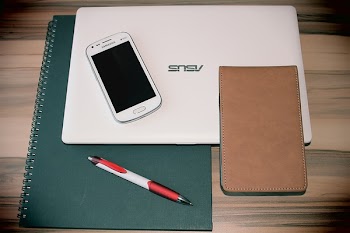 White Samsung Smartphone on White Asus Laptop