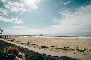 White Sand and Sea Under Blue Sky