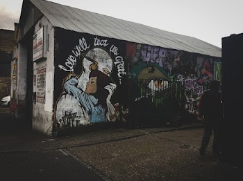 White Shed With Wall Art and Graffiti