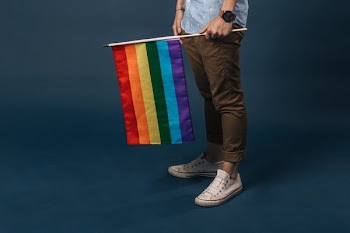 White Shoes Holding Small Pride Flag