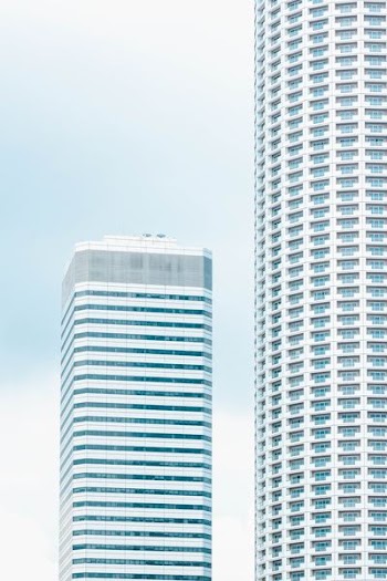 white skyscraper under white and blue skies