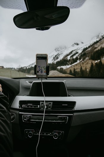 White Smartphone Docked on Car Windshield