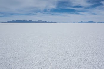 white snow field under white clouds at daytime