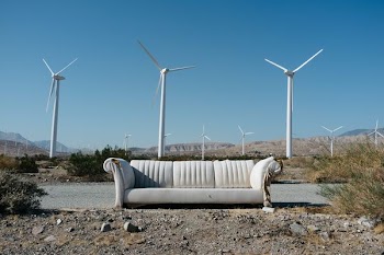 white sofa beside asphalt road