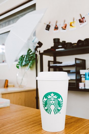 White Starbucks Disposable Cup On Brown Table