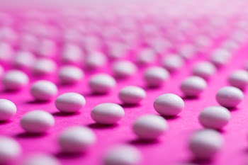 White Stone Fragment on Pink Surface