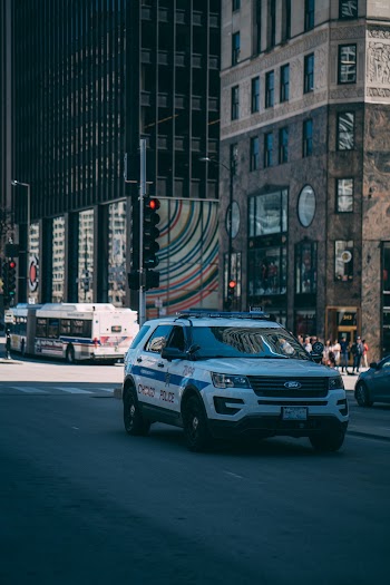 White Suv Passing by a Street in the City