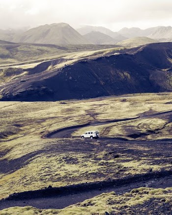 white SUV travelling on road during daytime