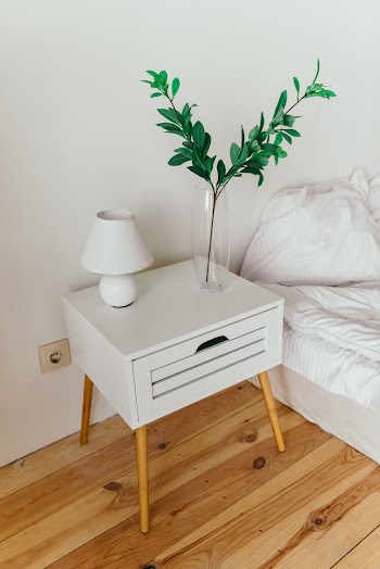 White Table Lamp on Top of Nightstand