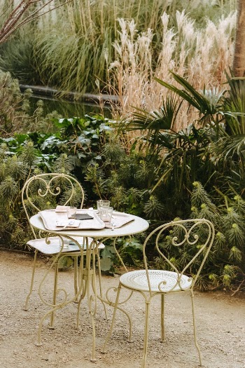 White Table With Chairs on Gray Sand