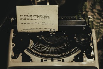 White Typewriter With Paper Inserted