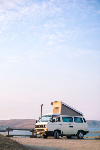 white van on brown soil at day time