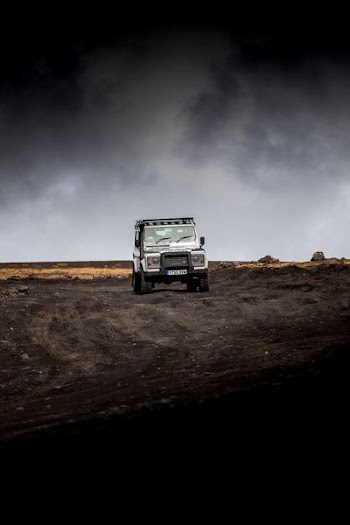 white vehicle on dirt road