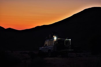 white vehicle park near mountain