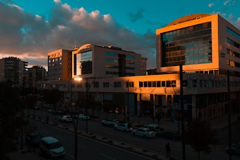White Vehicles Parked in Front of Gray Building
