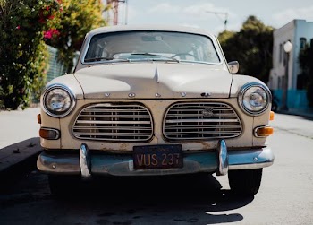 white Volvo car parked on roadside at daytime