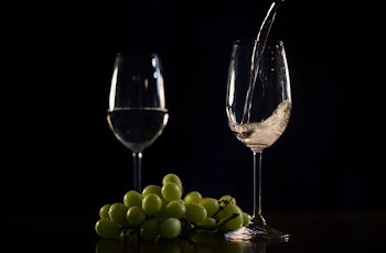 White Wine Pouring With Grapes