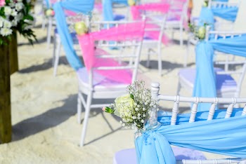 White Wooden Armless Chair on Sand