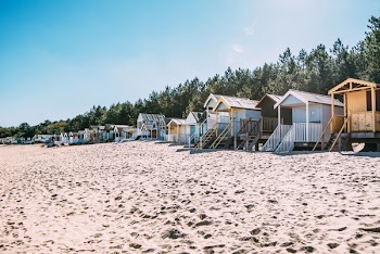 White Wooden Cottages by the Sea Under Clear Sky