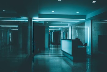 white wooden desk on hallway inside building