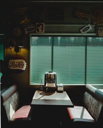 white wooden dining table in front of window