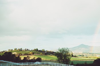 White Wooden Ranch Near Mountain Under Cloudy Sky