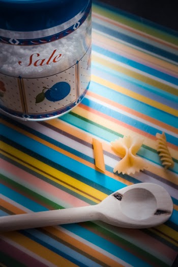 White Wooden Serving Spoon on Multicolored Textile