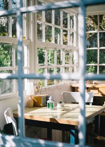 white wooden table near window