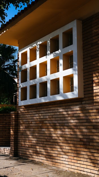 White Wooden Window Sill on Brown Brick Building