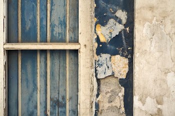white wooden window with peeling paint