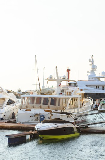 White Yacht Parked on Wooden Dock