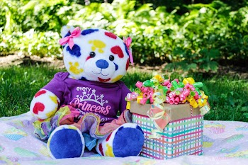 White, Yellow, Red, and Blue Teddy Bear Beside Gift Box