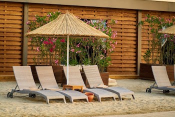 Wicker Outdoor Lounge Chairs On Sand 