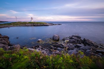 wide angle photo of body of water under cloudy sky
